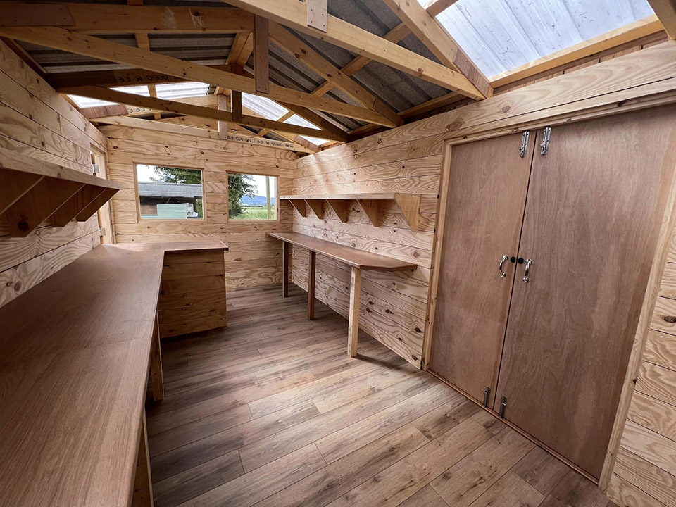 Wooden interior of a small cabin workspace.
